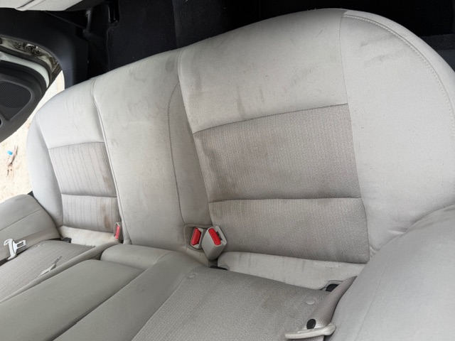 Nissan backseat with stains before interior detail